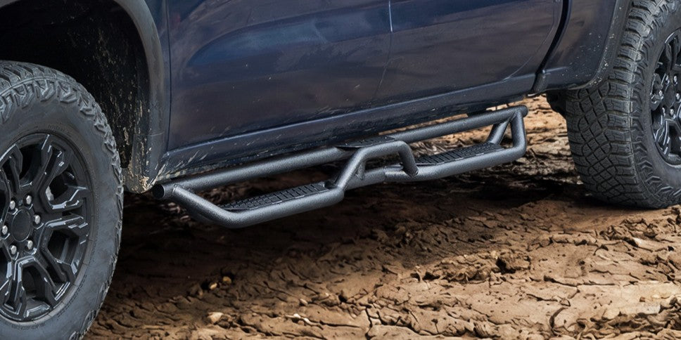 trucks with running boards running on road