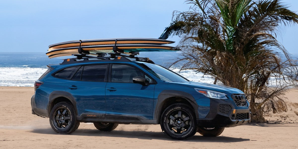 The surfboard is secured on the roof rack.